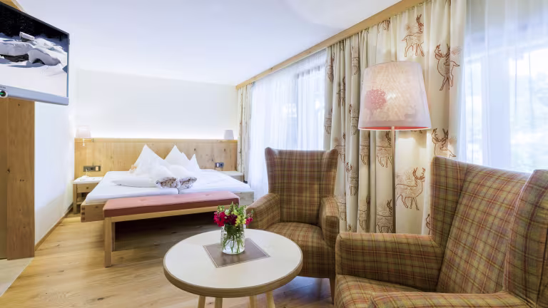 Helles, gemütliches Hotelzimmer mit Möbeln.